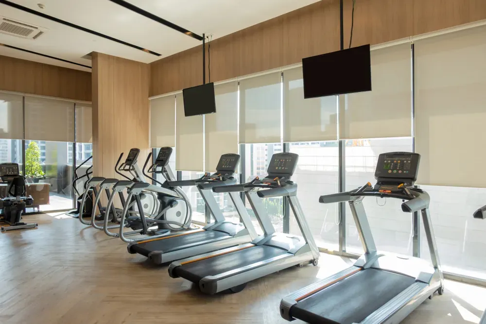 Commercial treadmills in a gym setting, requiring regular repair and maintenance.